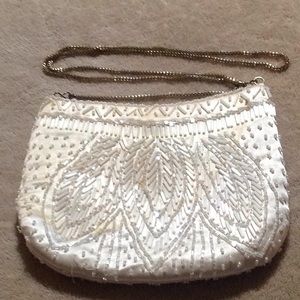 Off white beaded bag, chain strap & snap closure.